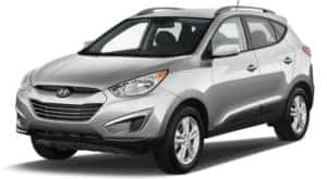 A silver 2010 used Hyundai Tucson on white
