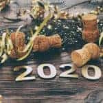 Ribbons and wine corks are behind '2020' for New Year's Eve.