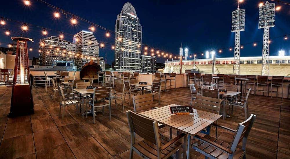 The roof deck of the AC Hotel Cincinnati at the Banks is shown at night.
