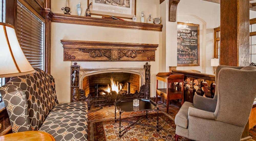 The warm, lodge interior of the Best Western Premier Mariemont Inn in Cincinnati, OH, is shown.