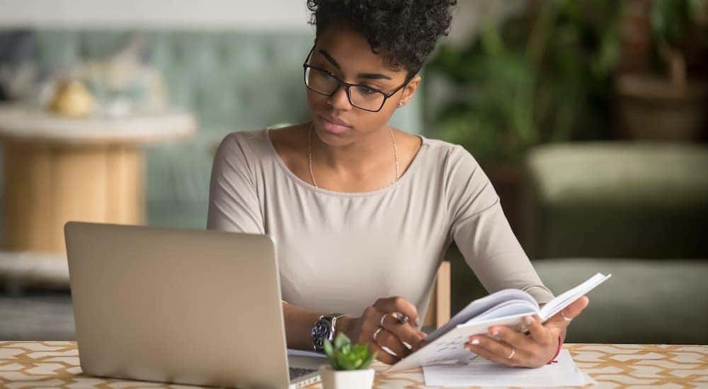 A person is shown working on a laptop.