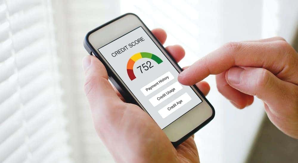 A person is shown checking their credit score.