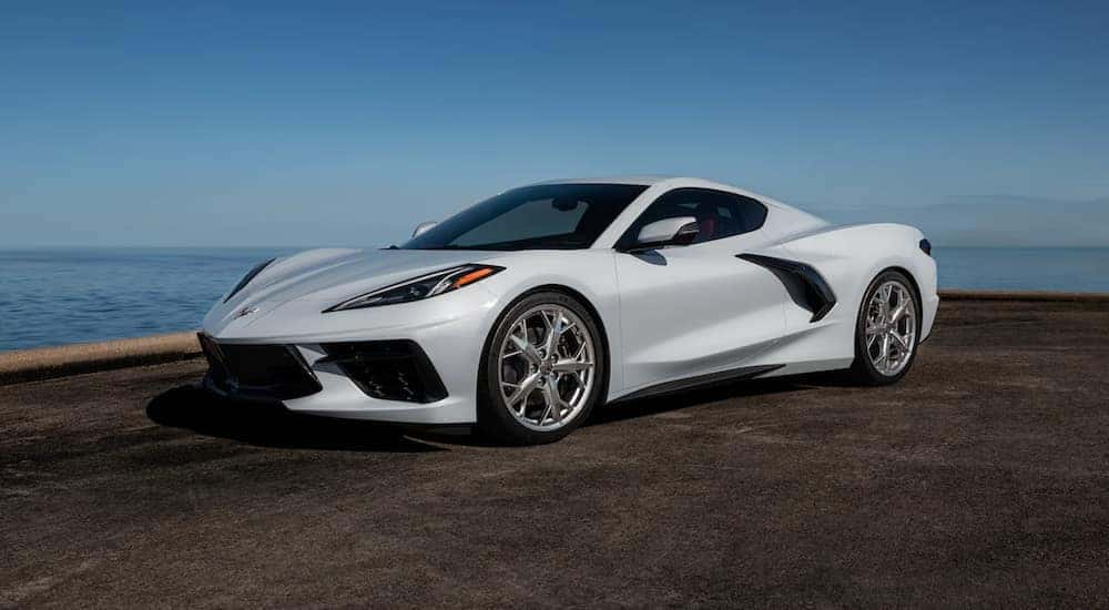 A white 2021 Chevy Corvette parked near water.