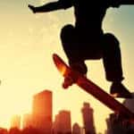 Skateboarder skateboarding at sunrise city