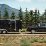 A black 2019 Chevy Silverado 1500 towing a trailer.
