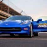 A blue 2014 Chevy Corvette Stingray parked on a track.