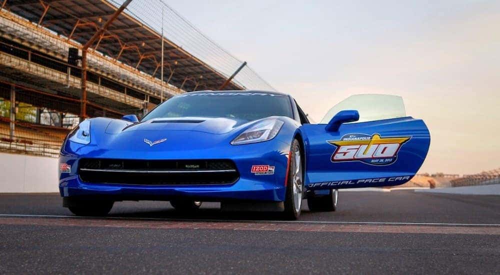 A blue 2014 Chevy Corvette Stingray parked on a track.