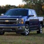 A blue 2014 Chevy Silverado 1500 Z71 parked on grass.