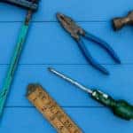 Old hammer and DIY tools overhead on wood background