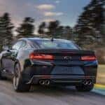 A black 2017 Chevy Camaro driving on a track.