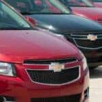 Five 2013 Chevy Cruzes in a line.