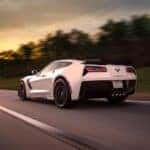 A white 2015 Chevy Corvette driving fast.