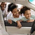 A family is shown looking inside a car at a Cincinnati Chevy dealer.
