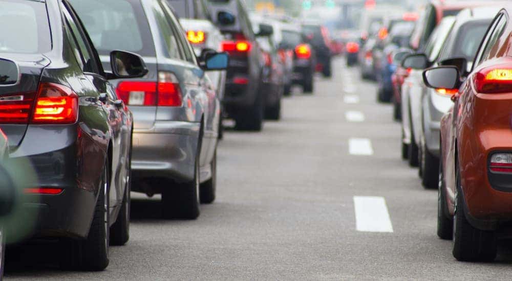 Two lanes of stopped traffic are shown on a highway.