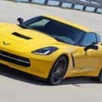 Yellow 2015 Chevy Corvette C7 driving on a track.