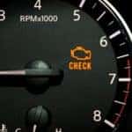 The check engine light is on on the gauge area of the dashboard.