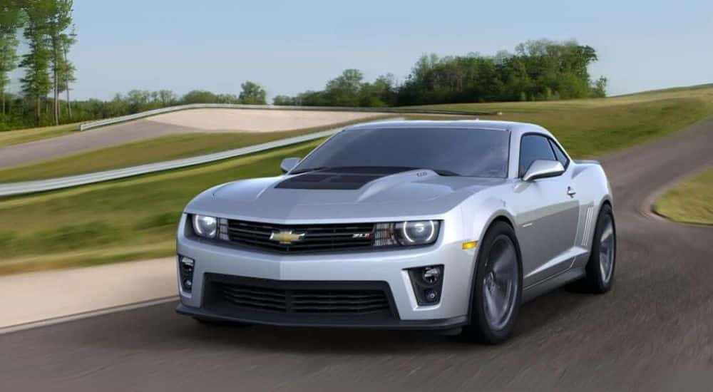 Grey 2014 Chevy Camaro ZL1 driving on a track.