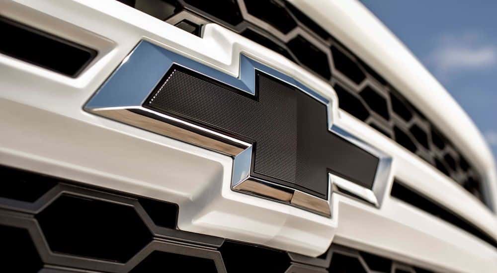 Close-up on the badge and grille of a 2015 Chevy Silverado 1500.