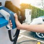 A person about to charge a car.