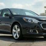 A black 2015 Chevy Malibu angled left.
