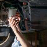 Someone changing an oil filter.