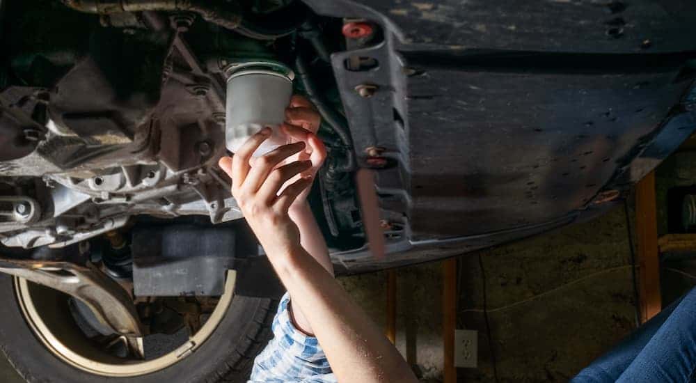 Someone changing an oil filter.