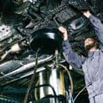 A mechanic performing an oil change.