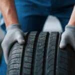 A mechanic handling a tire.