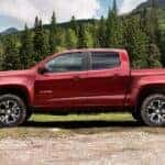 A red 2015 Chevy Colorado Z71 parked near trees.