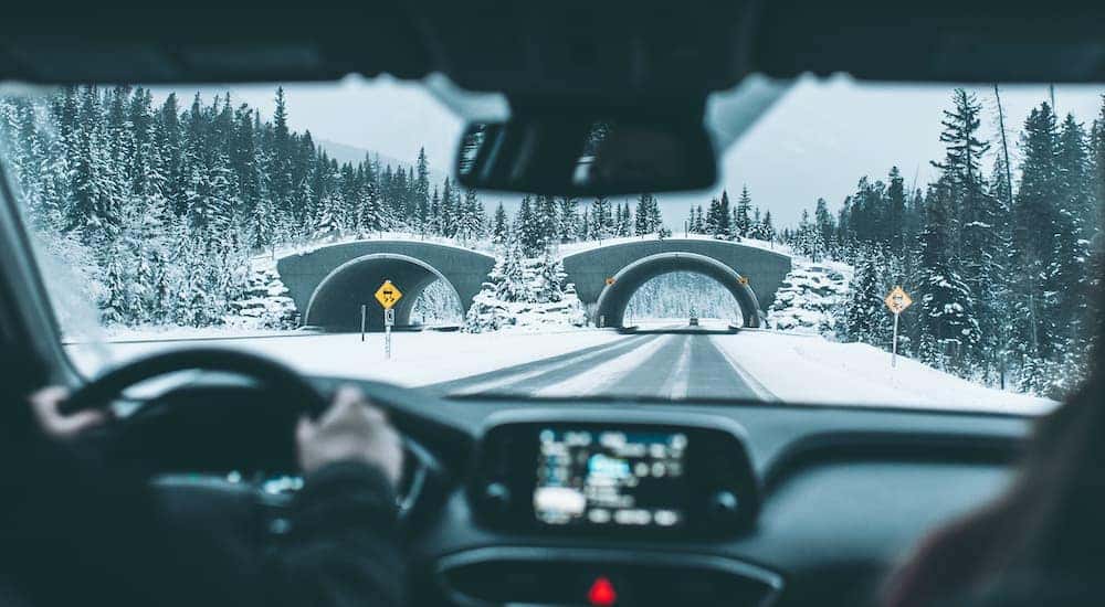 A highway and bridges are shown on a snowy day.