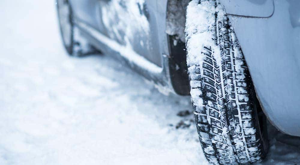 A close up shows show tires on a vehicle.