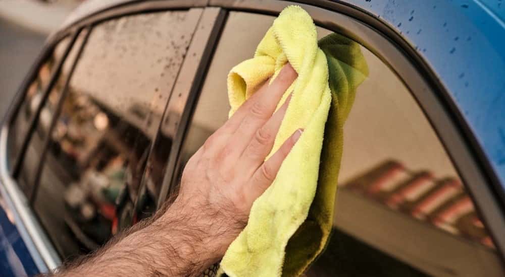 A person cleaning glass.