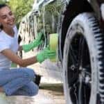 A person cleaning a car.