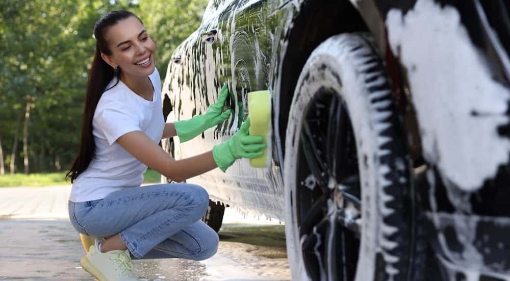 A person cleaning a car.