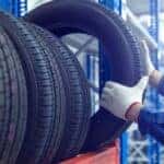A mechanic selecting a tire.