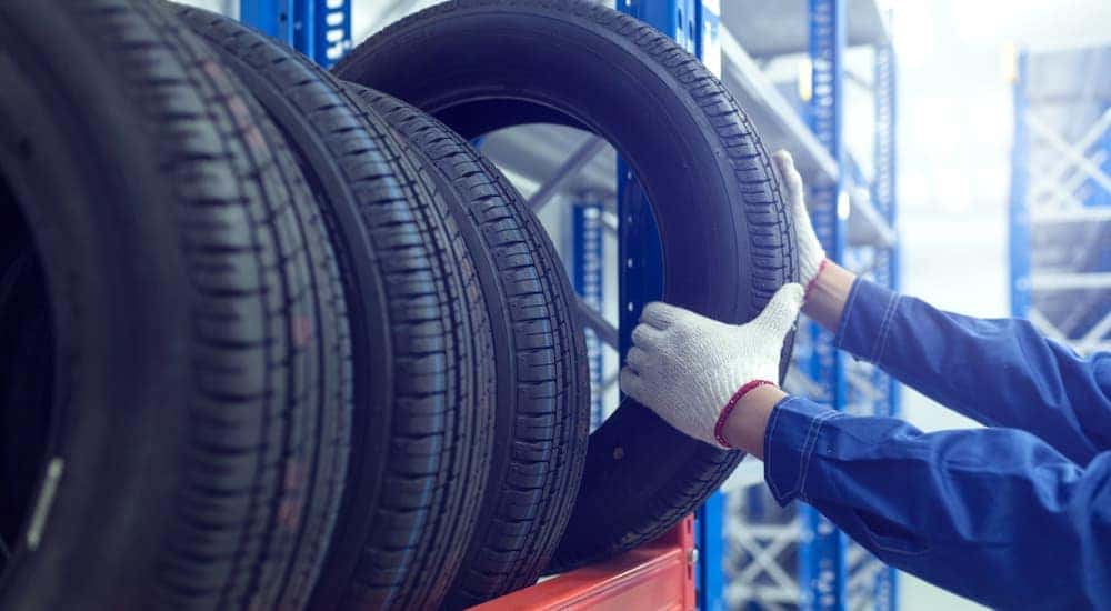 A mechanic selecting a tire.