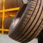 A mechanic holding a tire.