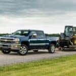 A blue 2015 Chevy Silverado 2500 HD from the side.