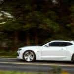 A white 2016 Chevy Camaro from the side.