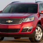 A red 2016 Chevy Traverse parked in a field.
