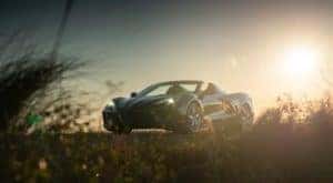 A black 2021 Chevy Corvette is shown in a field of tall grass after visiting one of the most popular Chevy dealers in Ohio, McCluskey Chevy.