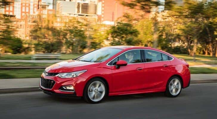 A red 2016 Chevy Cruze form the side.