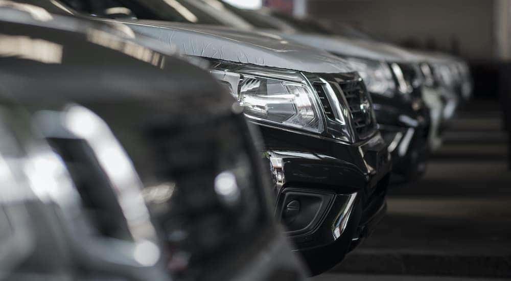 A close up shows a row of cars at a car lot thats does buy here pay here in Cincinnati.