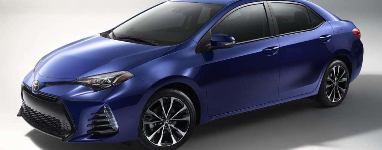 A dark blue 2017 used Toyota Corolla is angled left on white background.