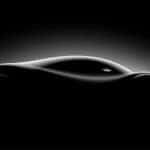 A dark sports car from the side.