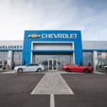 The front of the McCluskey Chevrolet building is shown against a cloudy sky.