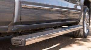 A closeup is shown of Chevy Silverado accessories like side steps on a silver 2017 Silverado.