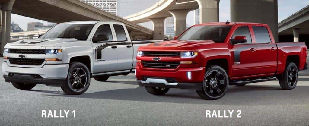 A white and a red 2017 Chevy Silverado 1500 Special Edition are shown parked in a city angled left.