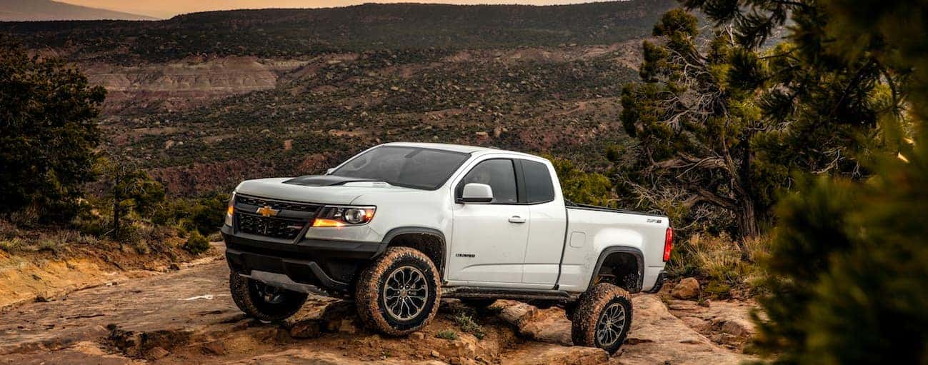 A white 2017 Chevrolet Colorado ZR2, Special Edition, is crawling up a rocky hill.