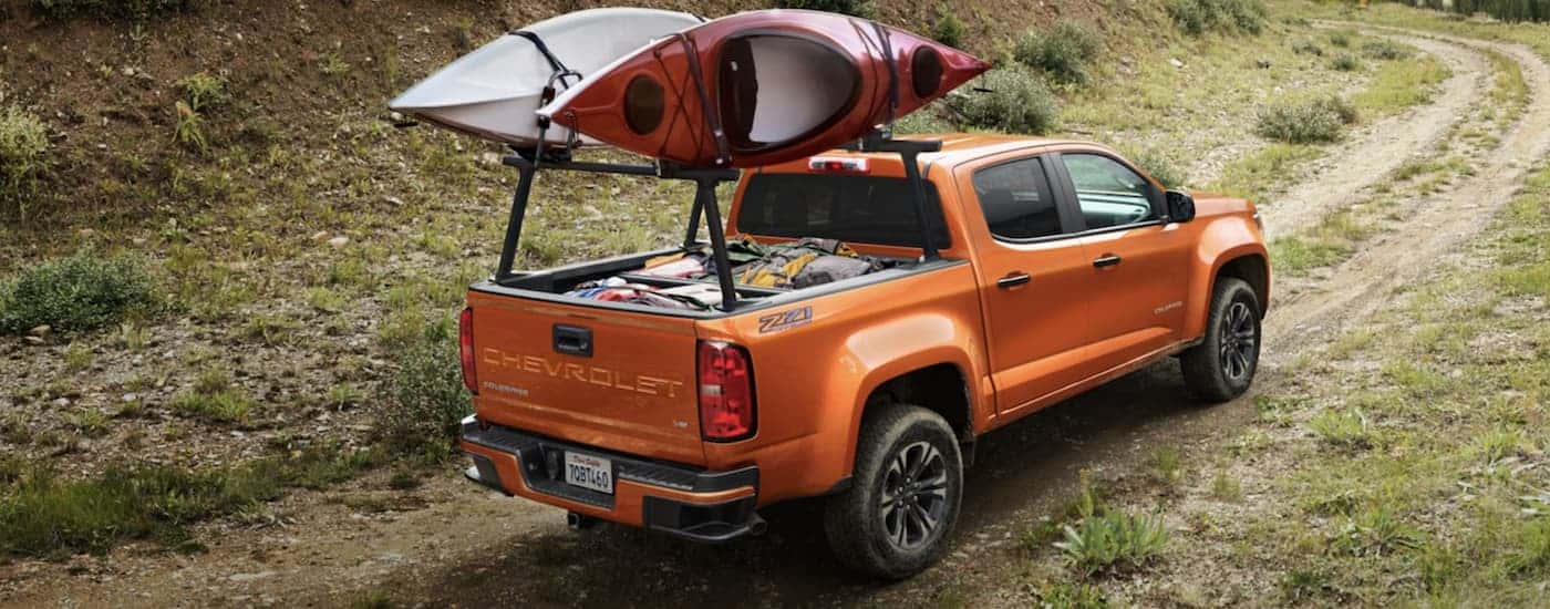 An orange 2021 Chevy Colorado driving off-road.